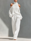 Women’s beige linen-blend high-waisted wide-leg trousers with pockets by FJØRNA, shown hanging with a relaxed fit and natural fabric texture.