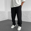 FJØRNA relaxed khaki knit trousers laid flat, showing soft fabric, relaxed fit, and classic style for casual wear.