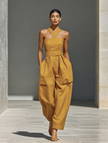 FJØRNA mustard linen-blend women's jumpsuit with crisscross neckline, relaxed fit, wide-leg pants, stylish and comfortable.