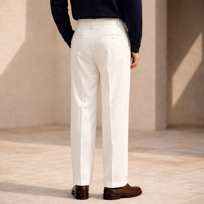 FJØRNA men's wide leg pleated trousers featuring a relaxed fit and tailored waistband, shown on a model against a neutral background.
