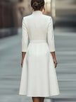 White textured belted midi dress with V-neckline by FJØRNA, featuring a flowing silhouette and stylish waist tie.