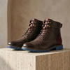 FJØRNA men's leather hiking boots with orthopedic support, durable outdoor shoes with sturdy soles and ankle protection.