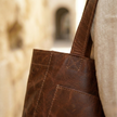 FJØRNA leather tote bag for women, anti-theft travel bag with spacious interior and secure design, shown in black leather.