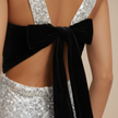 Sparkling glitter mini dress for women by FJØRNA featuring a fitted silhouette and shimmering fabric for stylish evening wear.