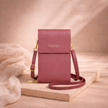 FJØRNA women's crossbody bag in black leather with adjustable strap, featuring front pocket and modern design.
