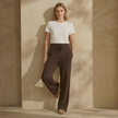 FJØRNA women's knit lounge trousers with cable knit pattern, comfortable casual pants in neutral color, relaxed fit.