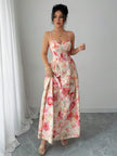 White sleeveless V-neck corset gown by FJØRNA, elegant maxi dress with fitted bodice and flowing skirt, perfect for formal occasions