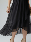 FJØRNA women's summer midi dress with V-neck, flowy fabric, and sleeveless design, perfect for warm-weather occasions.