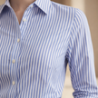 FJØRNA men's relaxed fit striped button-down shirt with long sleeves and collar, shown on a hanger.