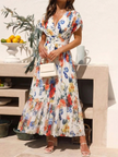FJØRNA women's floral pleated summer midi dress with lightweight fabric and adjustable straps, perfect for warm weather.