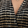 FJØRNA glitter long sleeve top for women, showcasing a shiny, stylish design with a fitted silhouette and long sleeves.