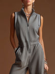 Dark grey FJØRNA cotton blend zip-up sleeveless jumpsuit displayed on a model, showcasing its modern, casual style.