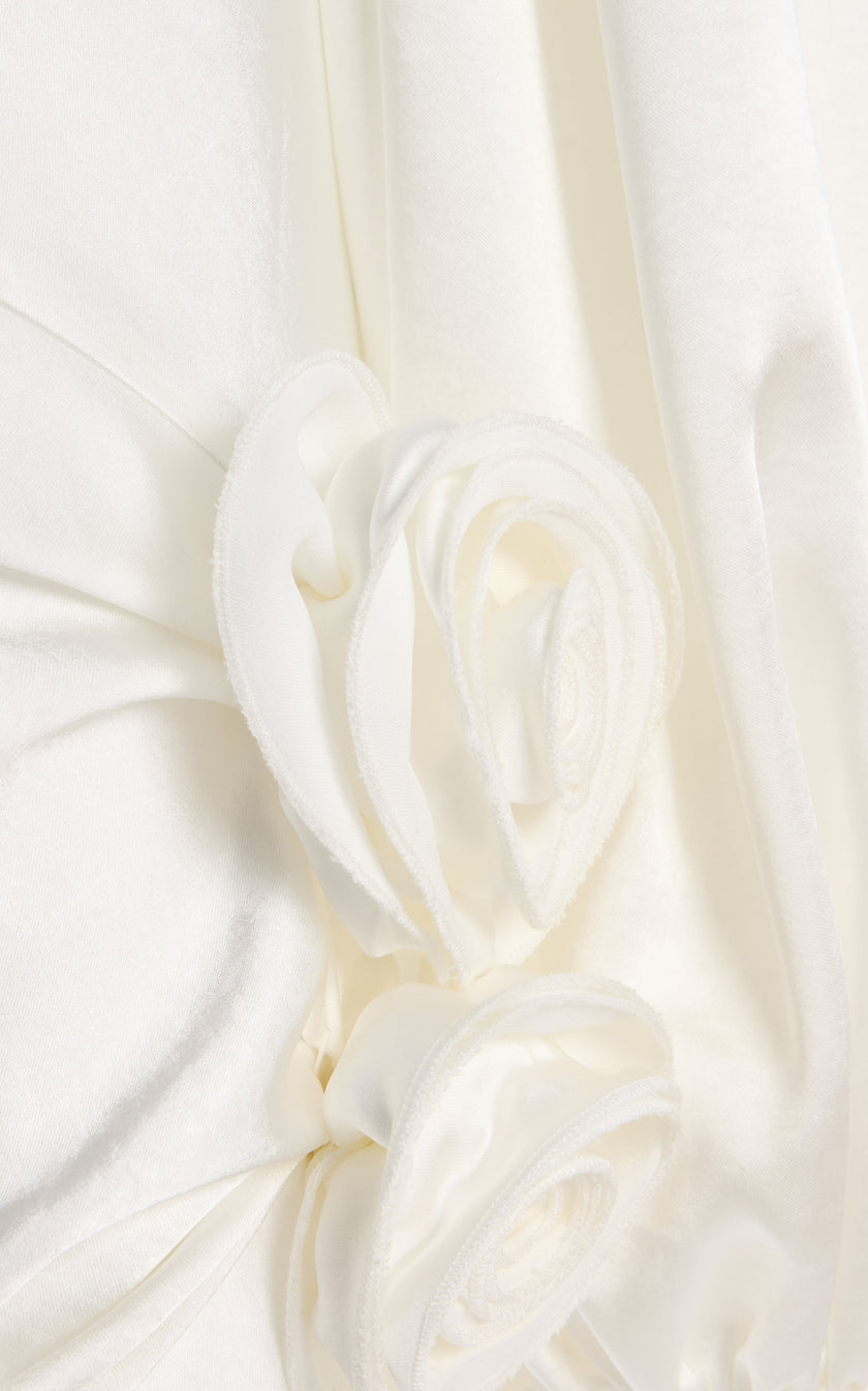 FJØRNA Vivir balloon-sleeve rose-detailed hammered satin maxi dress, elegant design with flowing silhouette and floral accents.