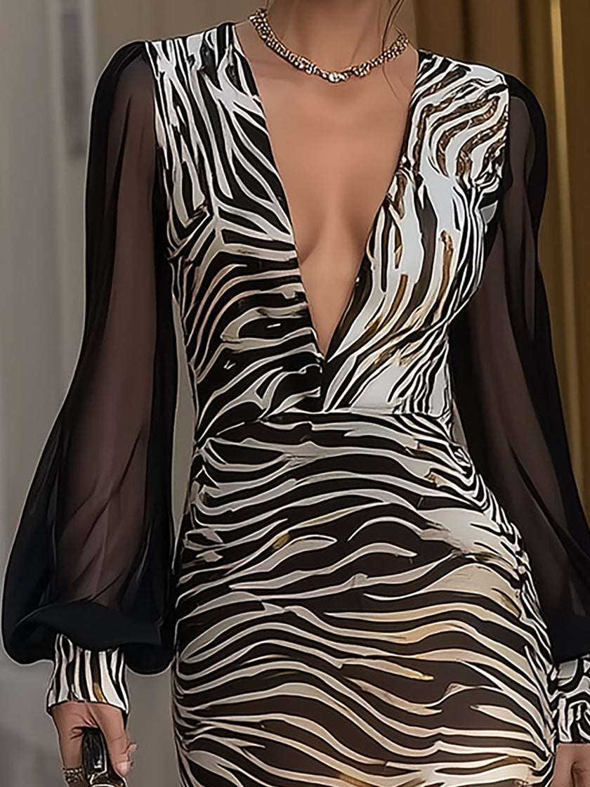 FJØRNA black sheer sleeve zebra print maxi dress with flowing fabric and long sleeves, stylish and elegant for evening wear.