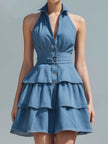 FJØRNA blue halter neck tiered ruffle denim mini dress with layered ruffles and sleeveless design, perfect for casual summer wear.