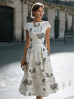 FJØRNA floral sketch print cap sleeve midi dress with a fitted waist and flowing skirt, perfect for summer or casual occasions.