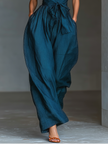 FJØRNA women's linen cross halter jumpsuit with wide-leg pants, tie waist, and side pockets, perfect for casual summer wear.