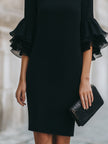 FJØRNA black dress with ruffled sheer sleeves, elegant and stylish, perfect for formal or evening wear.