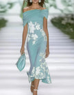 Green lace midi dress for women by FJØRNA, featuring intricate lace details and a flowing midi length.