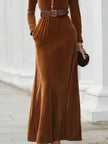 FJØRNA chestnut velvet maxi dress with shirt collar, flowing silhouette, long sleeves, and elegant design.
