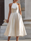 FJØRNA halter-neck pleated midi dress for women, featuring a flowing silhouette and elegant pleated design.