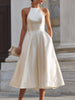 FJØRNA halter-neck pleated midi dress for women, featuring a flowing silhouette and elegant pleated design.