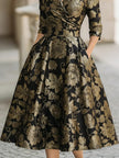 FJØRNA black and gold jacquard floral midi dress with intricate pattern and elegant fit, perfect for formal occasions.