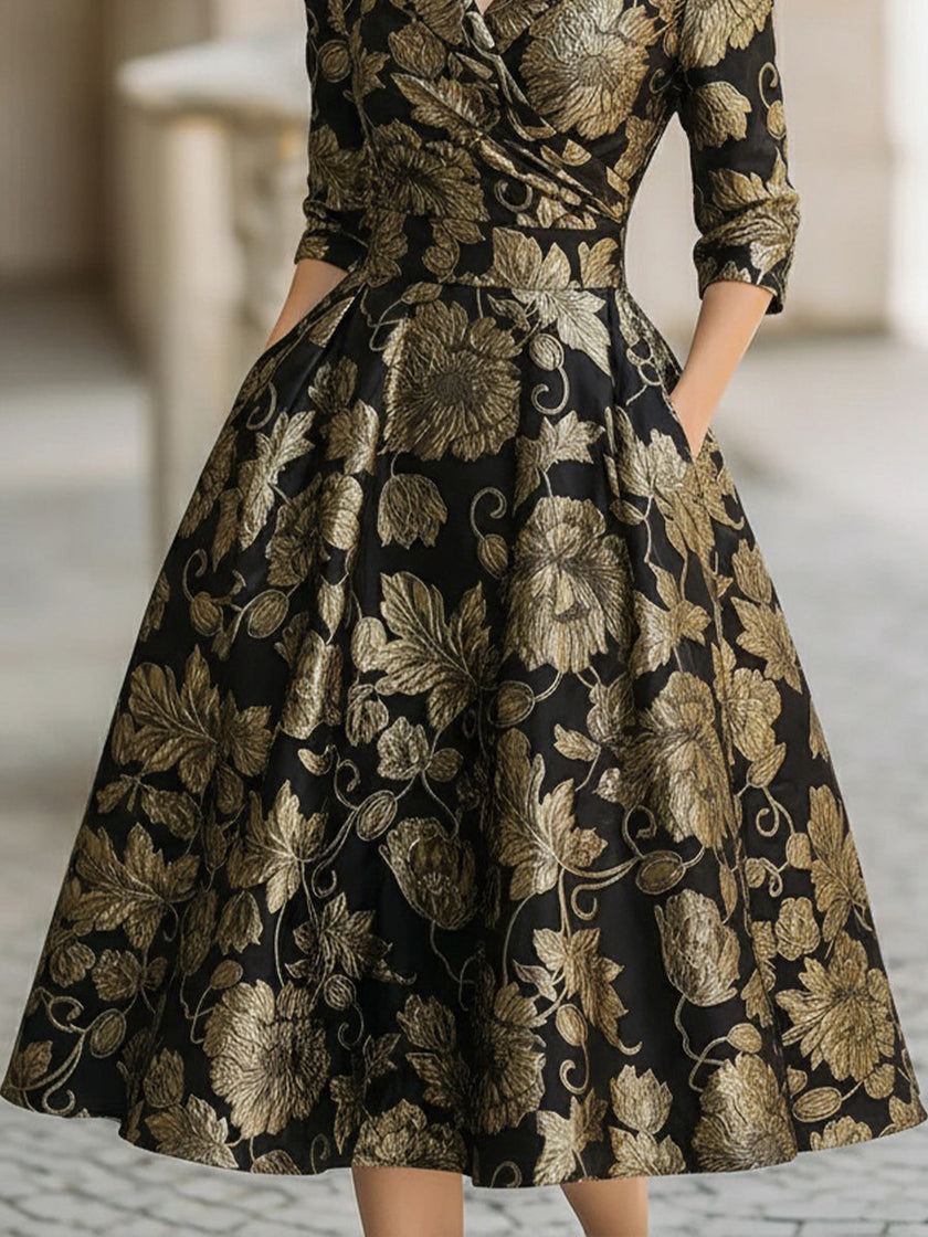 FJØRNA black and gold jacquard floral midi dress with intricate pattern and elegant fit, perfect for formal occasions.