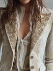Ivory velvet blazer with embroidered details and lace cuffs, long sleeve FJØRNA blazer shown on a model.