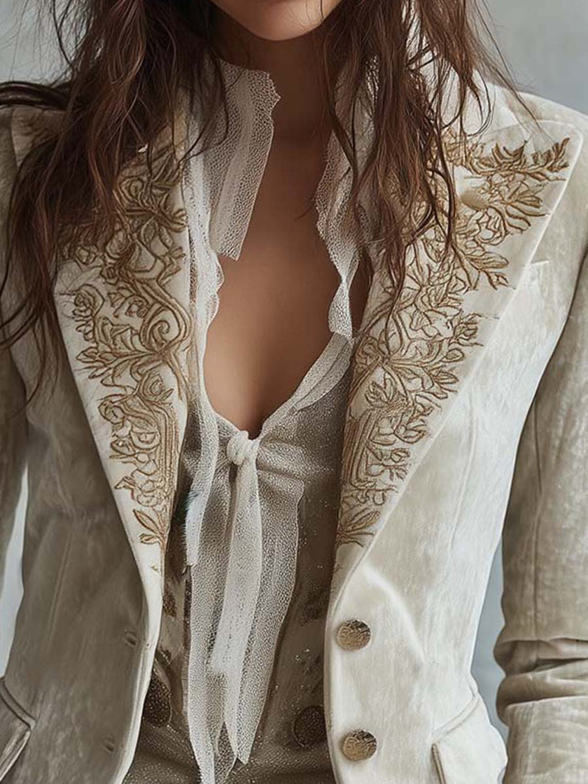 Ivory velvet blazer with embroidered details and lace cuffs, long sleeve FJØRNA blazer shown on a model.