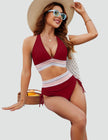 Women's high waist halter neck bikini set by FJØRNA, showcasing the shaping swimwear design in vibrant colors