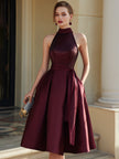 FJØRNA halter neck pleated midi dress with flowing fabric and elegant design, perfect for summer or formal occasions.