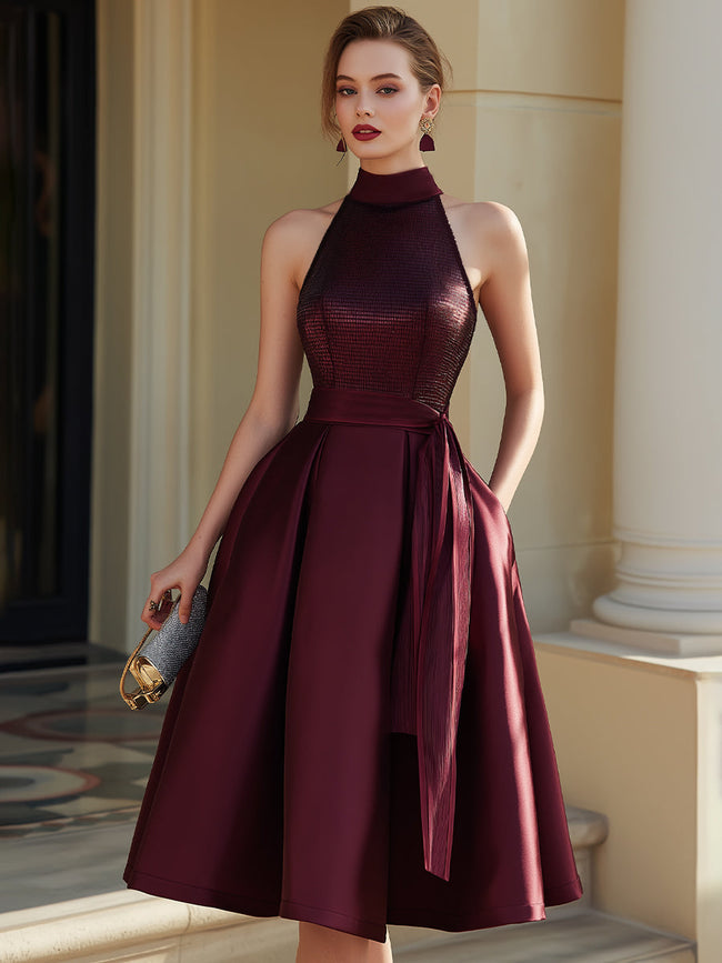 FJØRNA halter neck pleated midi dress with flowing fabric and elegant design, perfect for summer or formal occasions.