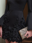 FJØRNA black bell-sleeve floral appliqué mini dress with a fitted silhouette and floral details on the fabric.