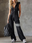 FJØRNA black sleeveless hooded jumpsuit with white striped pattern, casual style, front pockets, and relaxed fit.