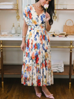 FJØRNA women's summer midi dress with floral print and pleated design, lightweight and elegant for warm weather.