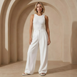 FJØRNA women's high waist wide leg tailored trousers showing a relaxed fit and clean design on a neutral background.