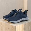 Men’s FJØRNA lightweight mesh trainers with breathable fabric and non-slip soles, shown in a side view.