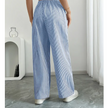 FJØRNA lightweight summer women's trousers with drawstring waist, breathable fabric, and side pockets, ideal for warm weather.