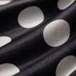 FJØRNA polka dot playsuit for women with V-neck and puff sleeves, stylish jumpsuit perfect for casual or summer wear.