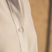 FJØRNA men's shirt, stylish top with a classic fit, featuring a button-down design and long sleeves, shown in a neutral color.