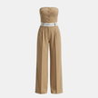 FJØRNA women's pinstripe strapless wide-leg jumpsuit with fitted bodice and flowing pant legs, set against a neutral background.
