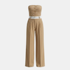 FJØRNA women's pinstripe strapless wide-leg jumpsuit with fitted bodice and flowing pant legs, set against a neutral background.