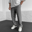 FJØRNA relaxed knit khaki trousers displayed flat, showing their soft, comfortable fabric and casual fit.