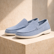 FJØRNA men's suede slip-on loafers shown in a natural indoor setting, featuring classic design and comfortable fit.