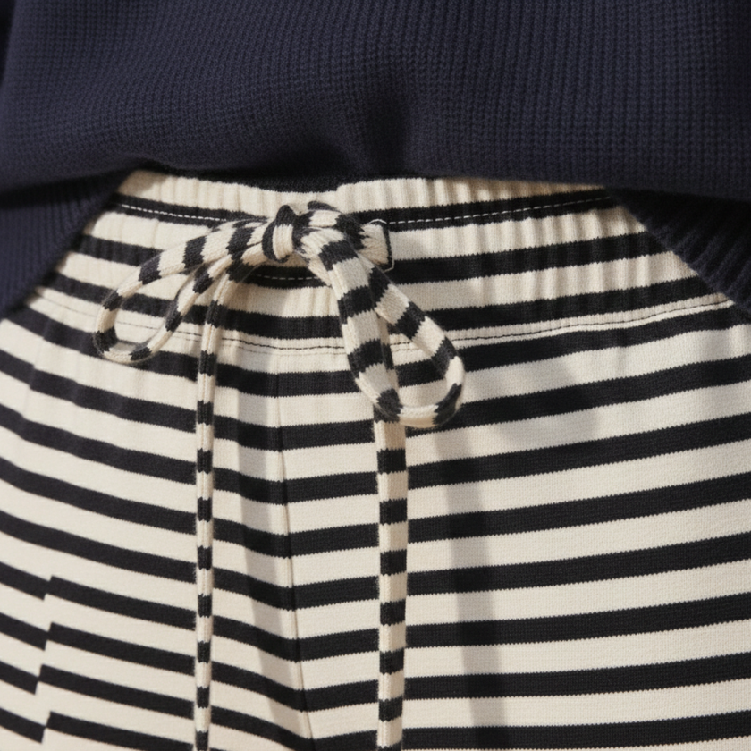 FJØRNA women's striped drawstring trousers, casual pants with relaxed fit and adjustable waist, shown with side view.
