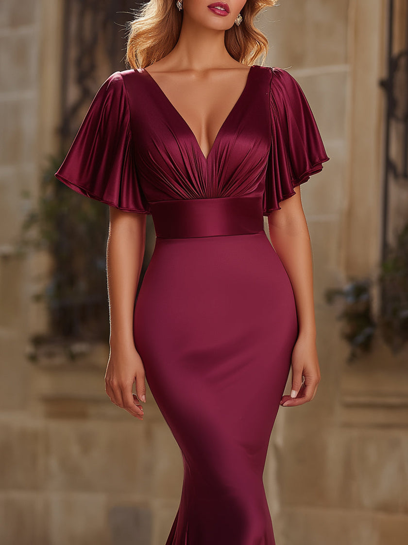 FJØRNA satin mermaid evening dress with flutter sleeves, elegant fit, and flowing silhouette for women’s formal occasions.
