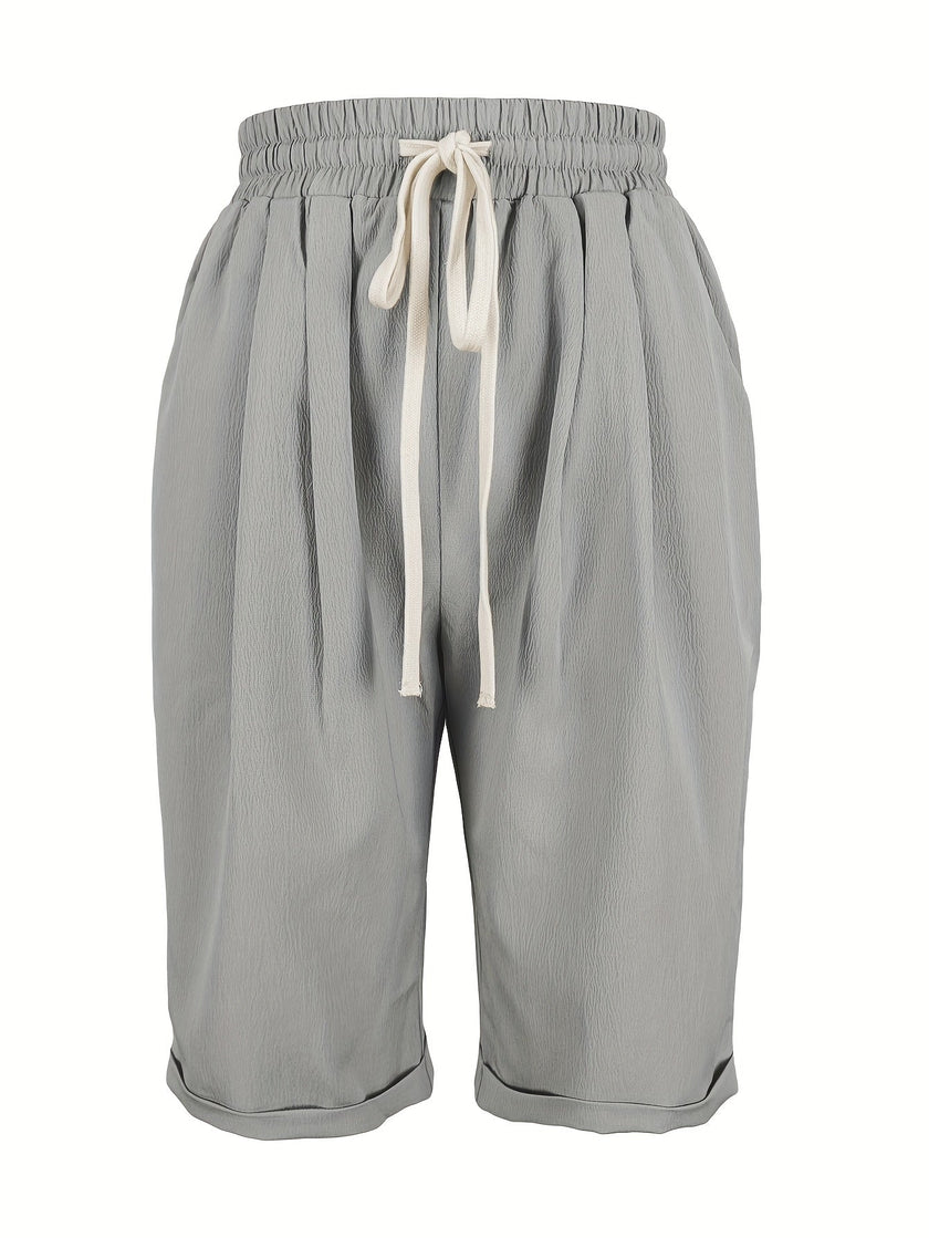 FJØRNA lightweight summer women's Capri pants with relaxed fit, drawstring waist, and breathable fabric, lying flat on a white background.