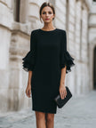 FJØRNA black dress with ruffled sheer sleeves, elegant evening dress with stylish detail and flowing silhouette.