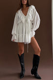FJØRNA solid color V-neck ruffled ruched long-sleeved vacation mini dress, casual wedding dress style, displayed on a hanger.